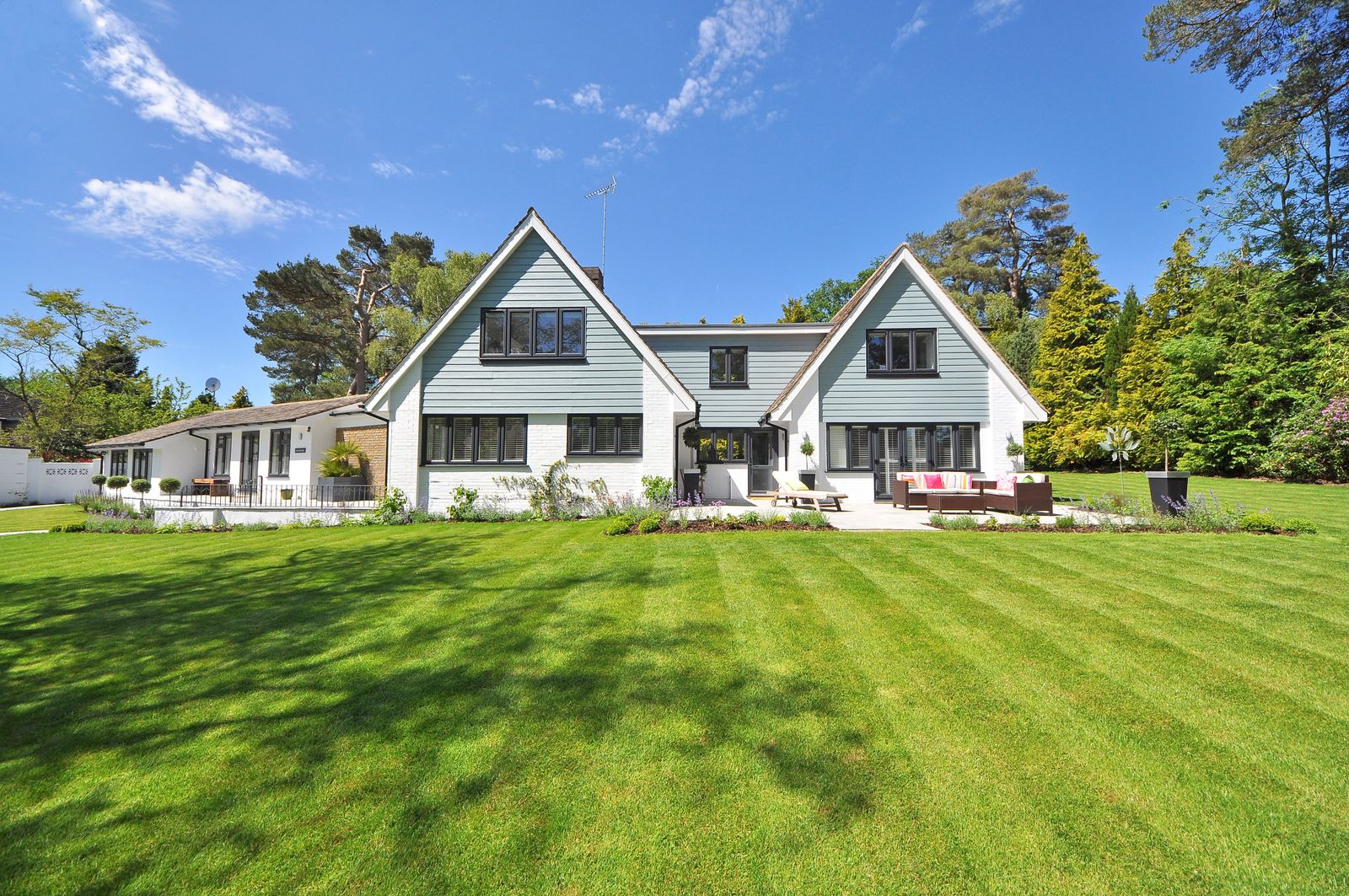 A striped back lawn in front of a house